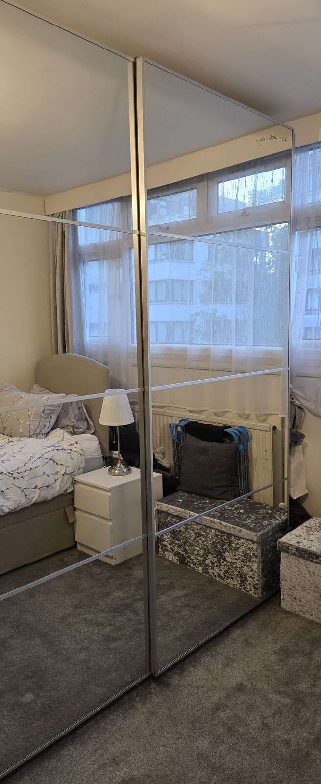 IKEA PAX wardrobe with mirrored sliding doors, assembled in a London bedroom